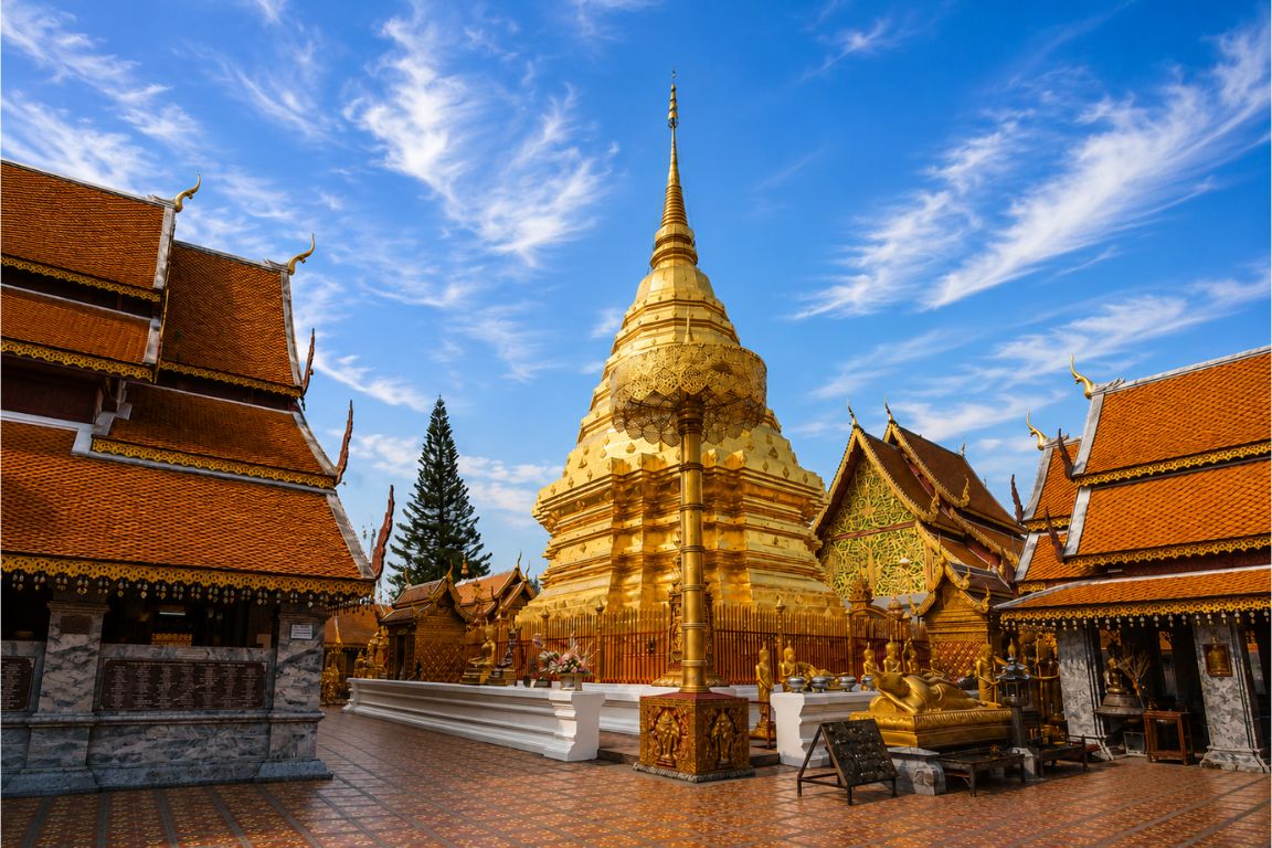 Beautiful Chiang Mai temple complex with golden pagoda and traditional Thai buildings during a Chiang Rai Tours tour with our agency